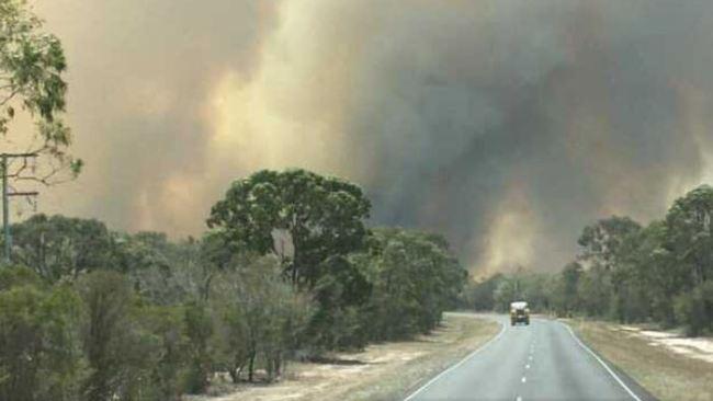 Smoke billows from a large grass fire at Woodgate, near Bundaberg. Picture: Brad Geizler