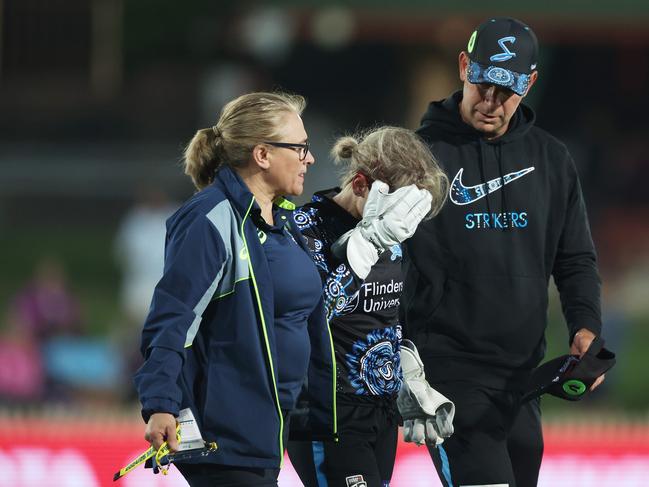 Strikers wicket-keeperer Bridget Patterson is helped from the field after being struck by a ball. Picture: Getty Images