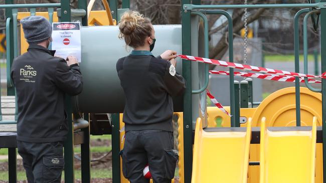 Parks Victoria staff closing down a playground in Albert Park. Picture: David Crosling