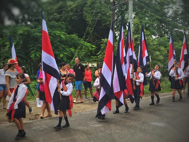 Children proudly carry Costa Rican flags at independence day celebrations. Picture: Gary Burchett