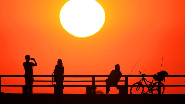 The sun sets at Middle Park beach ahead of several days of hot weather. Picture: Mark Stewart