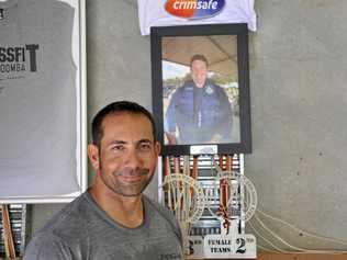 SPECIAL TRIBUTE: CrossFit Toowoomba owner Kent Strout stands in front of the gym's Senior Constable Brett Forte memorial. Picture: Jason Gibbs