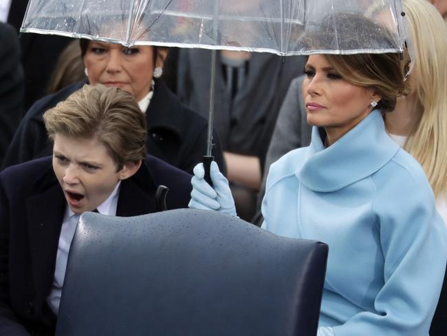 Melania was not thrilled with Barron’s form, and the lady behind was in turn not thrilled with Melania’s form bringing that massive umbrella. Picture: Chip Somodevilla/Getty Images