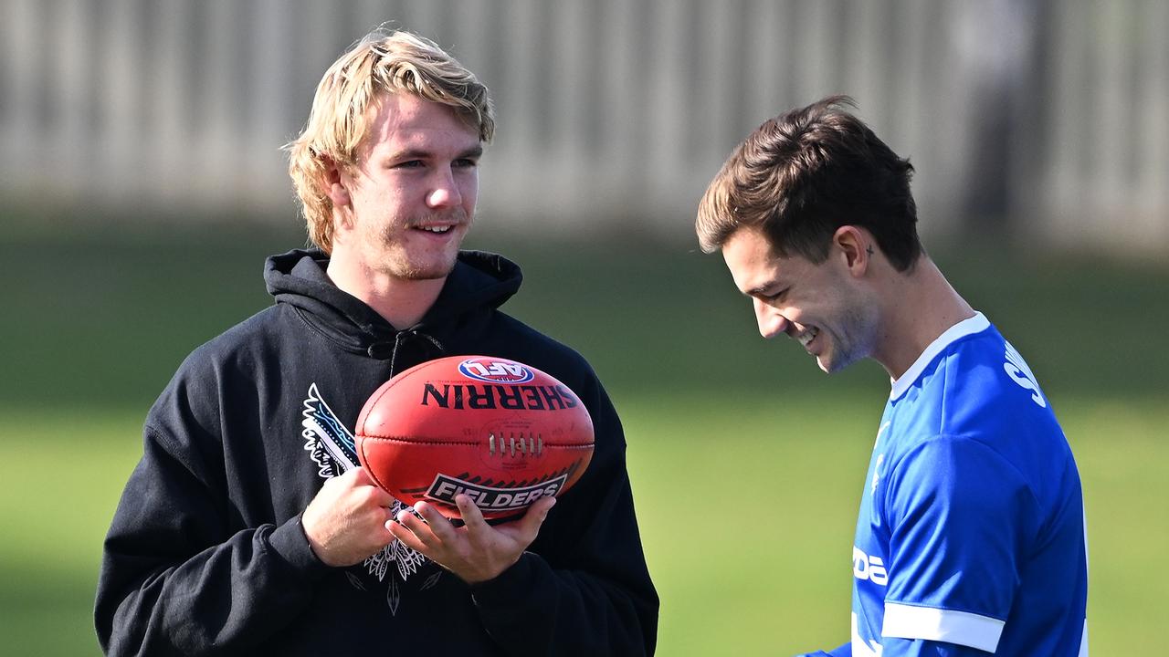 HOBART, AUSTRALIA – MAY 13: Jason Horne-Francis of the Power chats to Jy Simpkin of the Kangaroos during the round nine AFL match between North Melbourne Kangaroos and Port Adelaide Power at Blundstone Arena, on May 13, 2023, in Hobart, Australia. (Photo by Steve Bell/Getty Images)