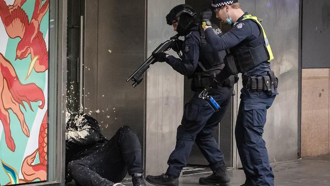 Police officers catch up with a protester amid an anti-lockdown and anti-vax march in Melbourne during the pandemic. Picture: Jason Edwards