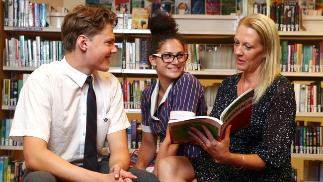 Barker College economics students Ben Maxwell and Melanie McDacy work with economics teacher Nicola Maloy. Picture: John Feder