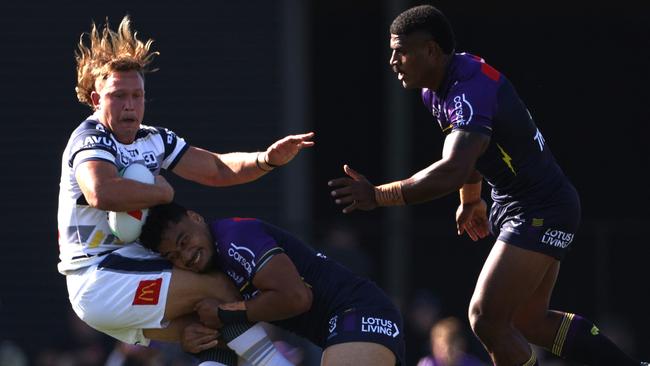 Cowboys forward Reuben Cotter is hit by a Storm defender. Picture: NRL Images