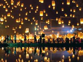 People release sky lanterns to pay homage to the triple gem: Budhha, Dharma and Sangha during Yi Peng festival. Picture: gagarych