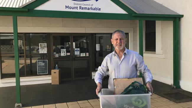 Former Mt Remarkable District Council chief executive Wayne Hart leaves the council's Melrose offices with his personal belongings.