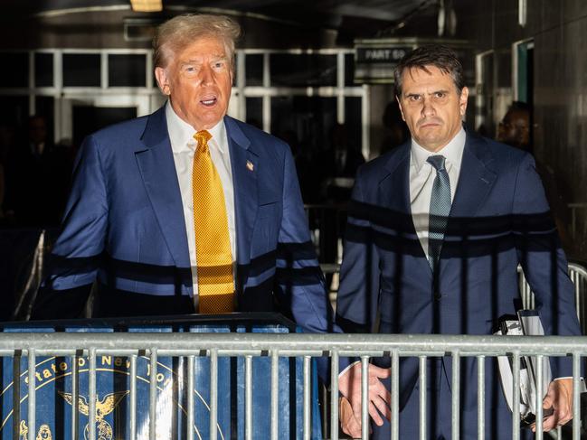 Donald Trump (L) speaks to the media with lawyer Todd Blanche (R) at his trial. The prosecution says “he’s done it again” with more gag order violations pending. Picture: AFP