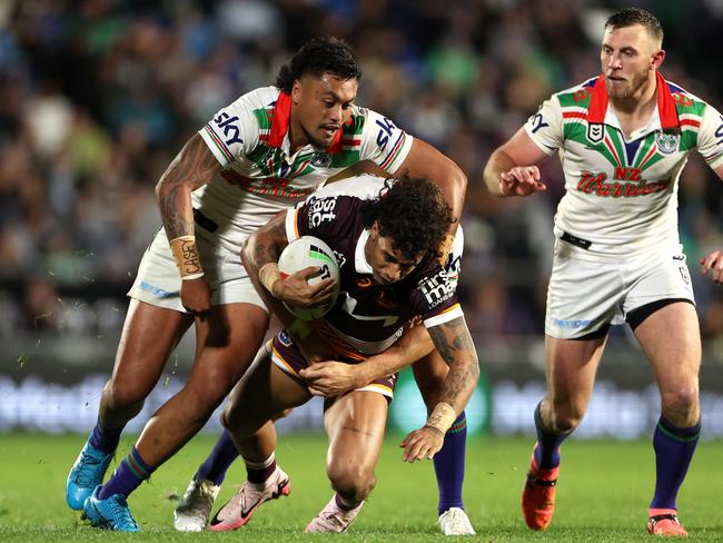 Tristan Sailor of the Broncos is brought down by the Warriors defence. (Photo by Hannah Peters/Getty Images)