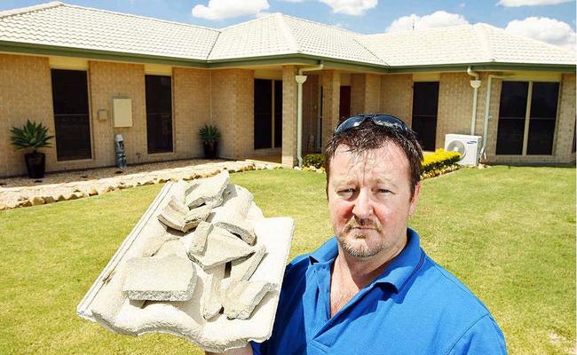 Plainland resident Shane Woods holds up some of the tiles damaged when lightning struck his home. . Picture: Claudia Baxter