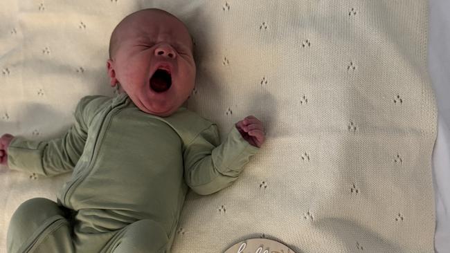 Tasmanian ironman champion Matt Bevilacqua and partner Brielle Cooper with their new baby Beau Peter born on the Gold Coast on May 28. Picture supplied by the family.