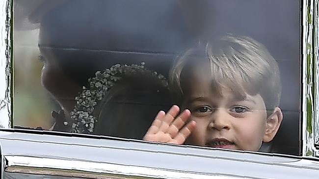 Back to his cheeky best. Prince George waves as he leaves in a car after attending the wedding of his aunt, Pippa Middleton, to James Matthews.  AFP PHOTO / POOL / Justin TALLIS