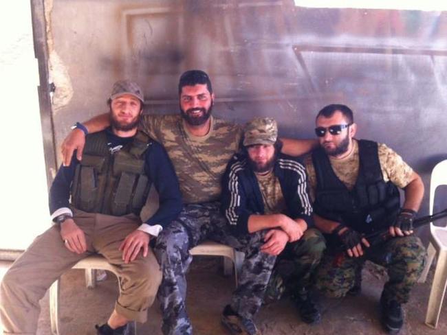 The trove of images documenting his time in Syria revealed what Hatahet (second from left) did when he told authorities he was going to Jordan.