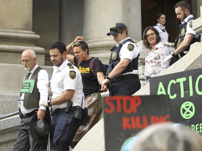 Climate change protesters are removed from Parliament House, where they staged a sit in. Picture: Dean Martin