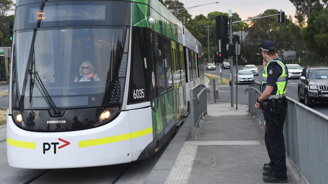 Police man tram stop on Plenty Road, Bundoora. Picture: Tony Gough