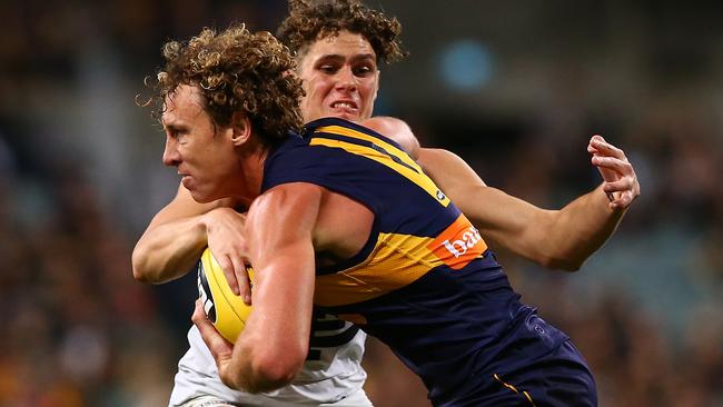 Matt Priddis tries to charge past Charlie Curnow. Picture: Getty Images