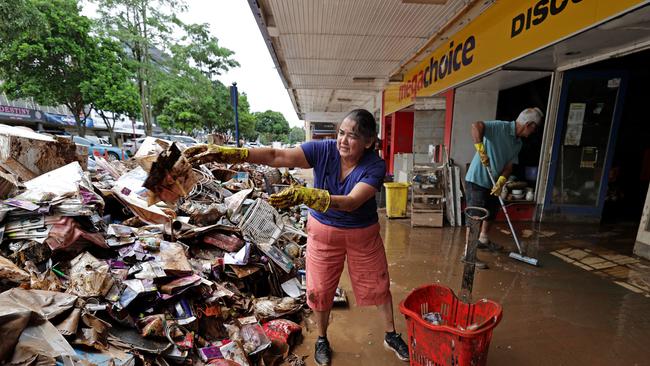 Shop owners Jaishree and Saras Solanki remove damaged stock and furniture from their flood damaged shops on Molesworth St. Picture: Toby Zerna