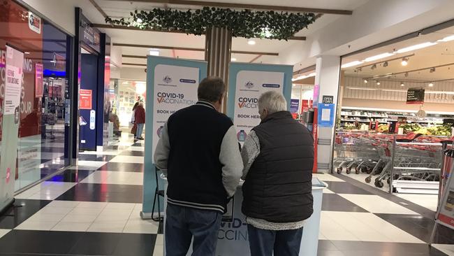 People enquiring about getting a Covid-19 jab at the Burnie Kmart Plaza shopping centre on Friday