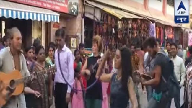 Australian and European tourists busking for cash in India. Picture: ABP News/YouTube