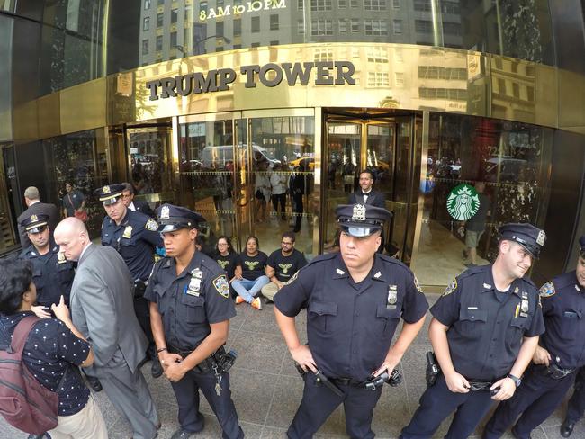 Anti-Trump protesters chain themselves to the doors of Trump Tower in New York on August 31, 2016. Picture: AFP/William Edwards