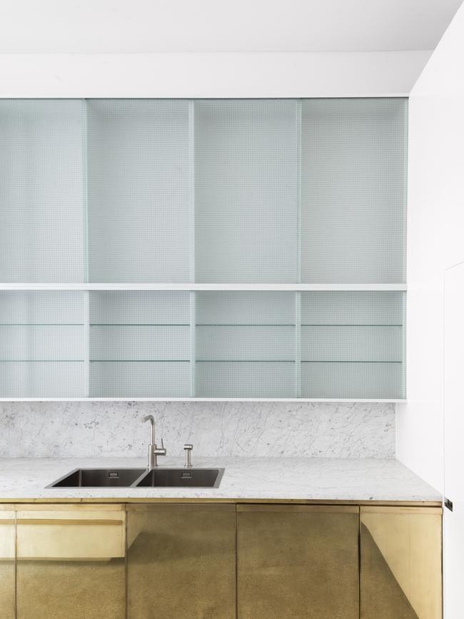 <b>AFTER: </b>The kitchen cupboards have been finished in brass.