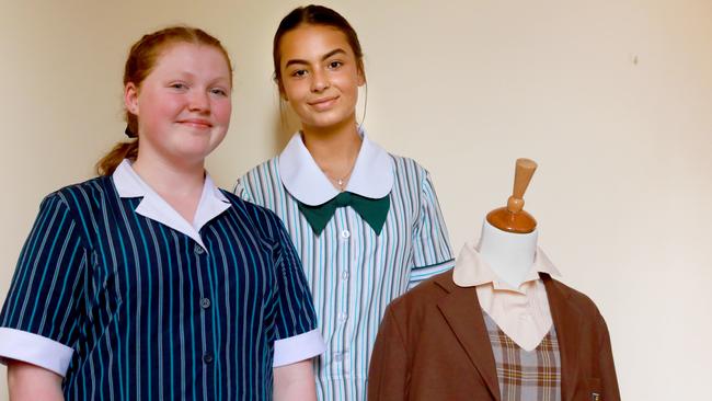 Mikayla Simpson and Isabella Dominello with the brown uniform worn for 40 years before 1995. Picture: Angelo Velardo