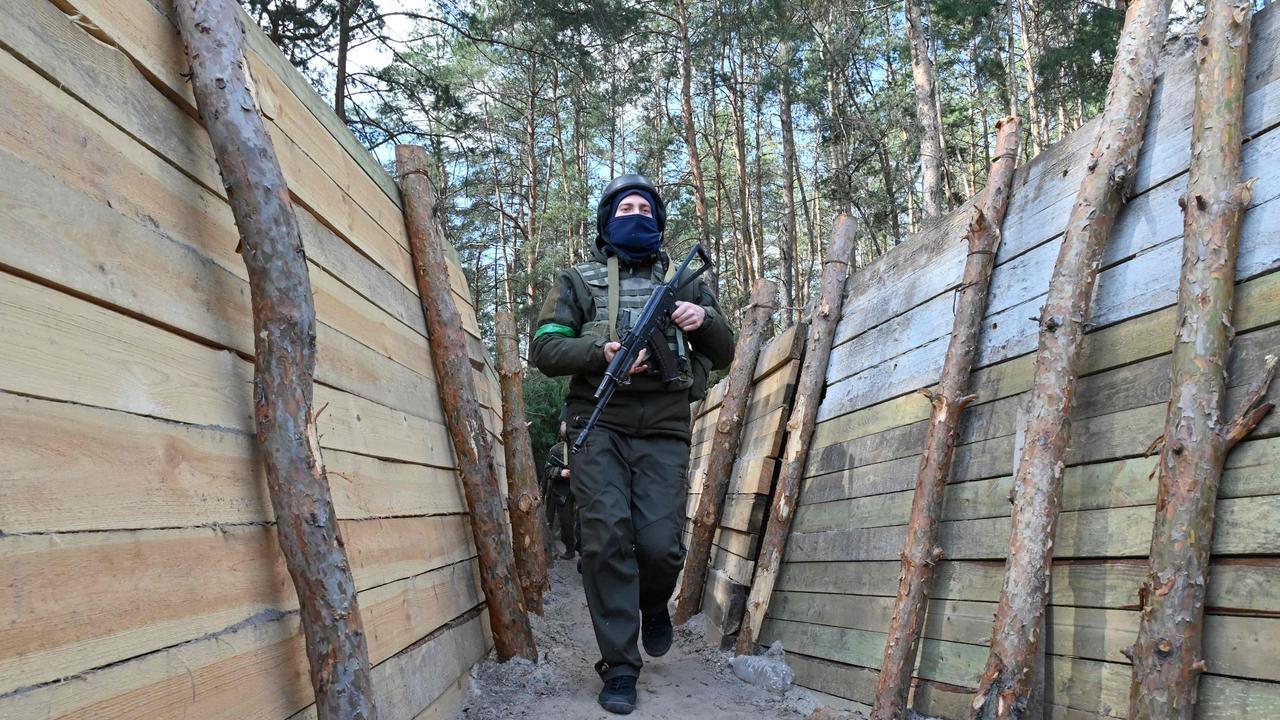 krainian servicemen walk along a trench during an exercise not far from the second largest Ukrainian city of Kharkiv. Picture: SERGEY BOBOK / AFP