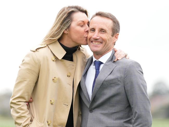 Damien Oliver is kissed by his wife Trish Oliver during a Damien Oliver Media Call where he announced he will retire in December at Ladbrokes Park Hillside Racecourse on August 30, 2023 in Springvale, Australia. (Photo by Scott Barbour/Racing Photos via Getty Images)