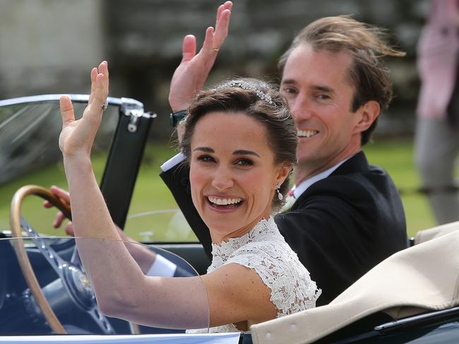 The happy couple wave to spectators on their way to the reception. PICTURE: Flynetpictures.co.uk\IMP Features.