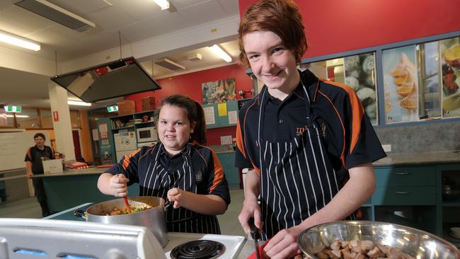 BYLINE - LUKE BOWDEN: Montrose Bay High School cooking students, Sarah Vidler, 13 and Rhys Robinson, 15 cooking meals that will be distributed by Second Bite.