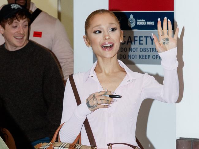 DAILY TELEGRAPH. Pop star Ariana Grande greets fans as she arrives at Sydney International Airport. Saturday 02/11/2024. Picture by Max Mason-Hubers