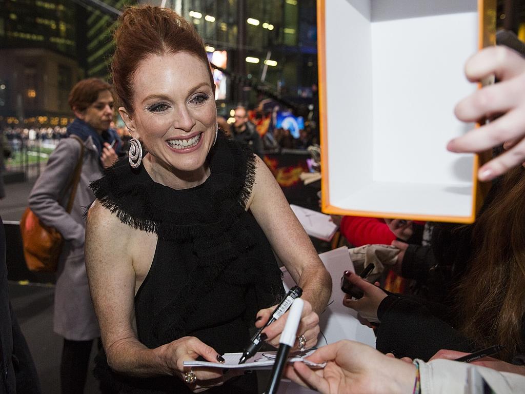 Actress Julianne Moore signs autopraphs for fans as she arrives at the world premiere of the film ‘The Hunger Games: Mockingjay - Part 2’ on November 4, 2015 in Berlin. Picture: AP