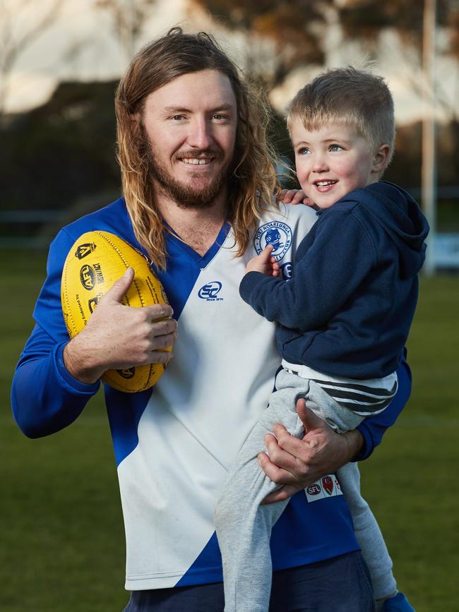 Port Noarlunga footballer Paul Randall with his son, Alfie, 4. Randall featured in his first game for the Cockledivers’ A grade since 2014 after an eye injury almost put an end to his playing days. Picture: Matt Loxton