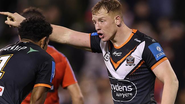 WOLLONGONG, AUSTRALIA - JUNE 07:  Alex Seyfarth of the Wests Tigers talks to team mate Jahream Bula during the round 14 NRL match between St George Illawarra Dragons and Wests Tigers at WIN Stadium on June 07, 2024, in Wollongong, Australia. (Photo by Jason McCawley/Getty Images)