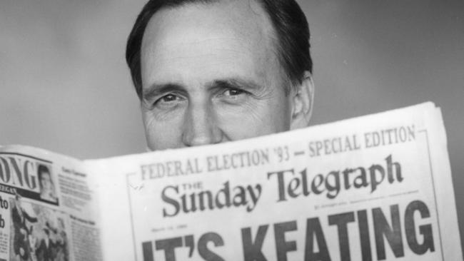 Keating holds up a copy of The Sunday Telegraph, a day after his party's victory in 1993.