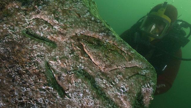 A diver inspects a quartzite block with an engraving of a pharaoh, indicated by hieroglyphic inscriptions on the stone as Seti I, father of Ramses II, on the seabed of the harbour of Alexandria, Egypt, in 2010. It’s one of the more unusual finds in the depths of the ocean. Picture: Franck Goddio &amp; Hilti Foundation, Christoph Gerigk/AP