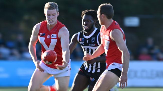 Port Adelaide’s Martin Frederick closes in on North Adelaide’s Harrison Wigg in the Magpies’ thrilling eight-point win at Alberton Oval on Saturday. Picture: Keryn Stevens