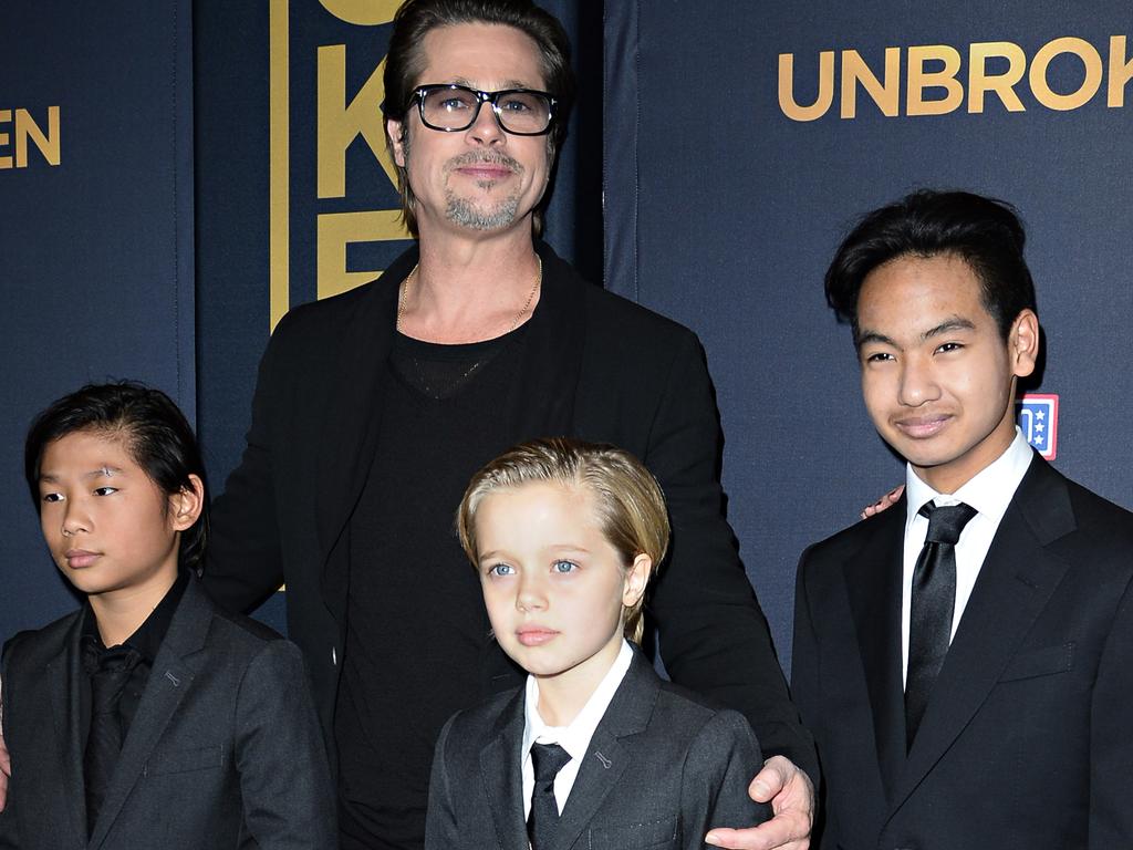 Brad Pitt, with Pax, Shiloh, and Maddoz in 2014, is said to be “distraught” over his son’s accident. Picture: AFP