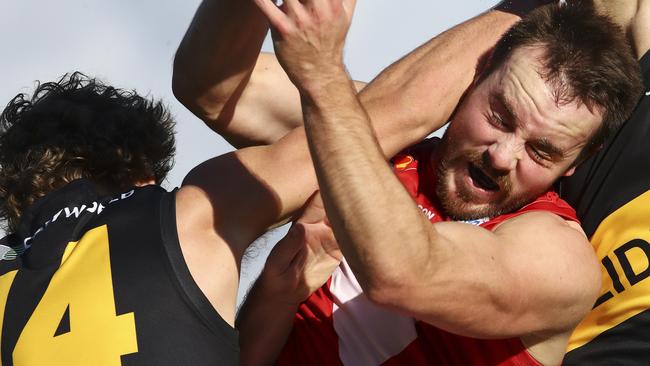 North Adelaide’s Max Thring in the pack against Glenelg’s Jack Haarsma. Picture: SARAH REED