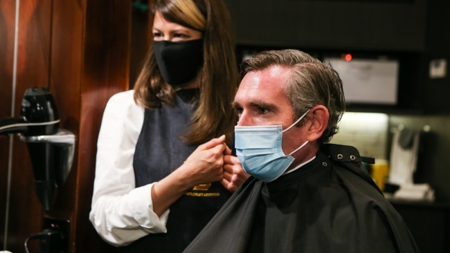 NSW Premier Dominic Perrottet receives a haircut at Barberhood men's hair stylists on Monday morning. Picture: Getty Images