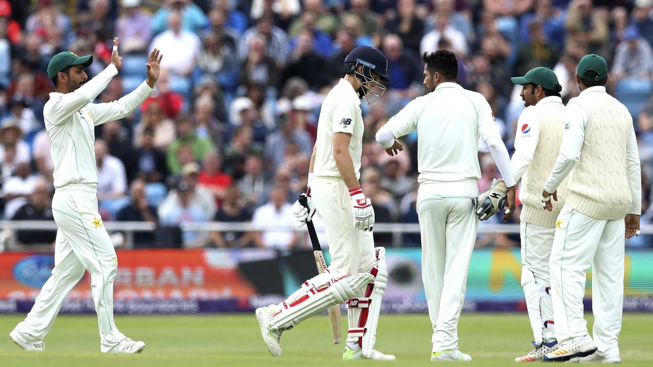 Joe Root shows his dejection as Mohammad Amir celebrates taking his wicket during day two of the second Test between England and Pakistan at Headingley.