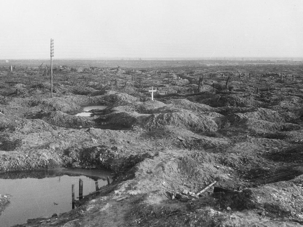 The lonely cross on the barren landscape at Pozieres, marking the grave of Tasmanian soldier Captain Ivor Margetts killed in action on July 24, 1916. The grave was later obliterated by the Germans. Picture: Australian War Memorial/E00532