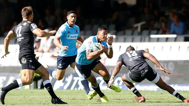 Waratahs Israel Folau (C) runs with the ball during the SuperXV rugby union match between Sharks and Waratahs at The Kings Park Stadium.