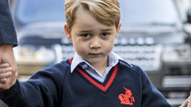 Britain's Prince George (C) accompanied by Britain's Prince William (L), Duke of Cambridge arrives for his first day of school at Thomas's Battersea School. Picture: AFP