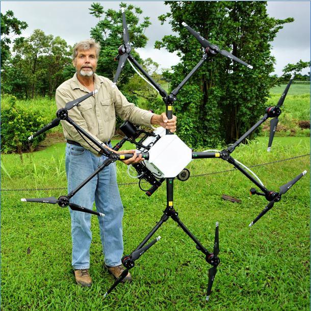 Department of Agriculture and Fisheries cane extension officer Marcus Bulstrode and the spray drone that is capable of delivering precision weed control. It can carry 10L and fly for about 10 minutes before it returns automatically to its point of launch. Picture: Department of Agriculture and Fisheries.