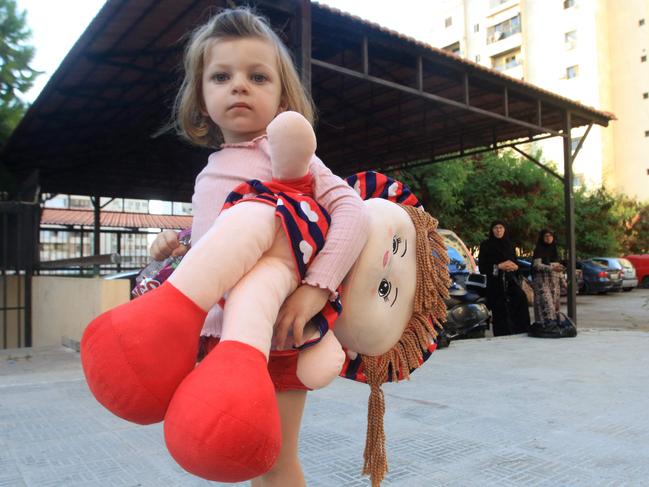 A little girl flees south Lebanon.