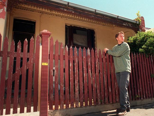 Greg Armstrong stands in front of the home in Easey St 20 years after the killings.