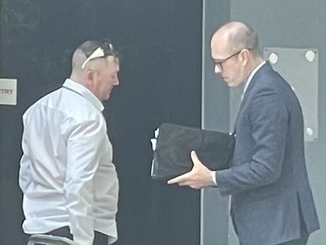 Corey Dobson, 44, (white shirt) talks to his lawyer outside Wyong Local Court where he was sentenced to an ICO for 15 months for drugs, weapons and fireworks offences. Picture: NewsLocal